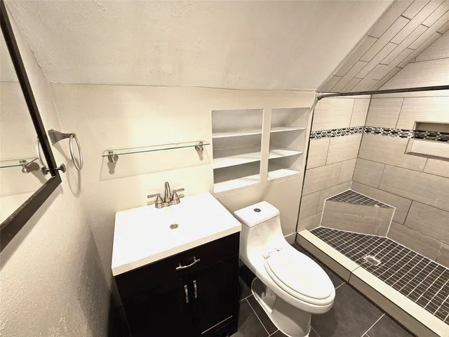 a bathroom with a sink mirror vanity and toilet