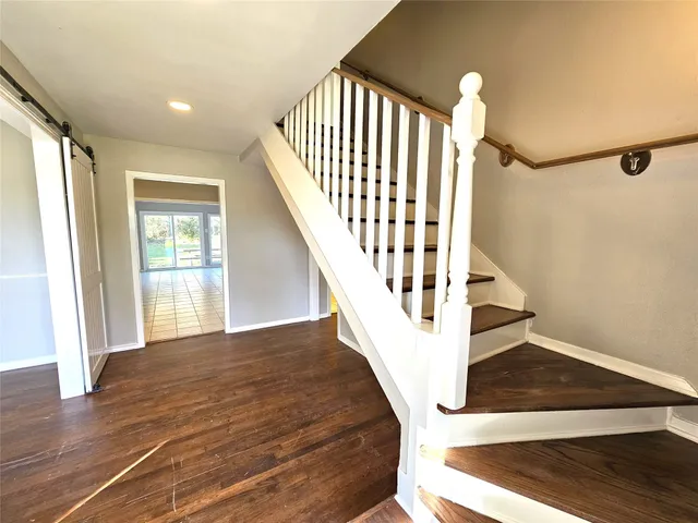 a view of entryway and hall with wooden floor