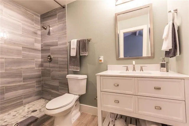 a bathroom with a sink toilet a mirror and shower