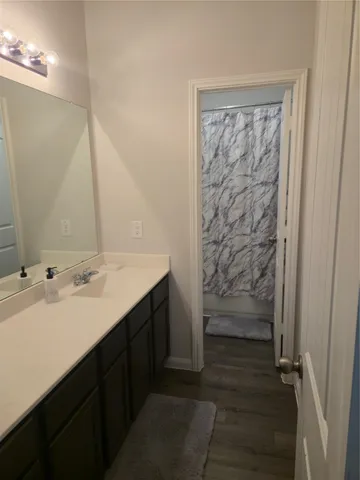 a bathroom with a double vanity sink a toilet and a mirror