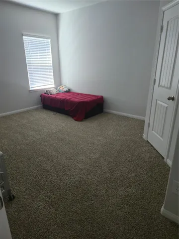 a room with a bed and a window