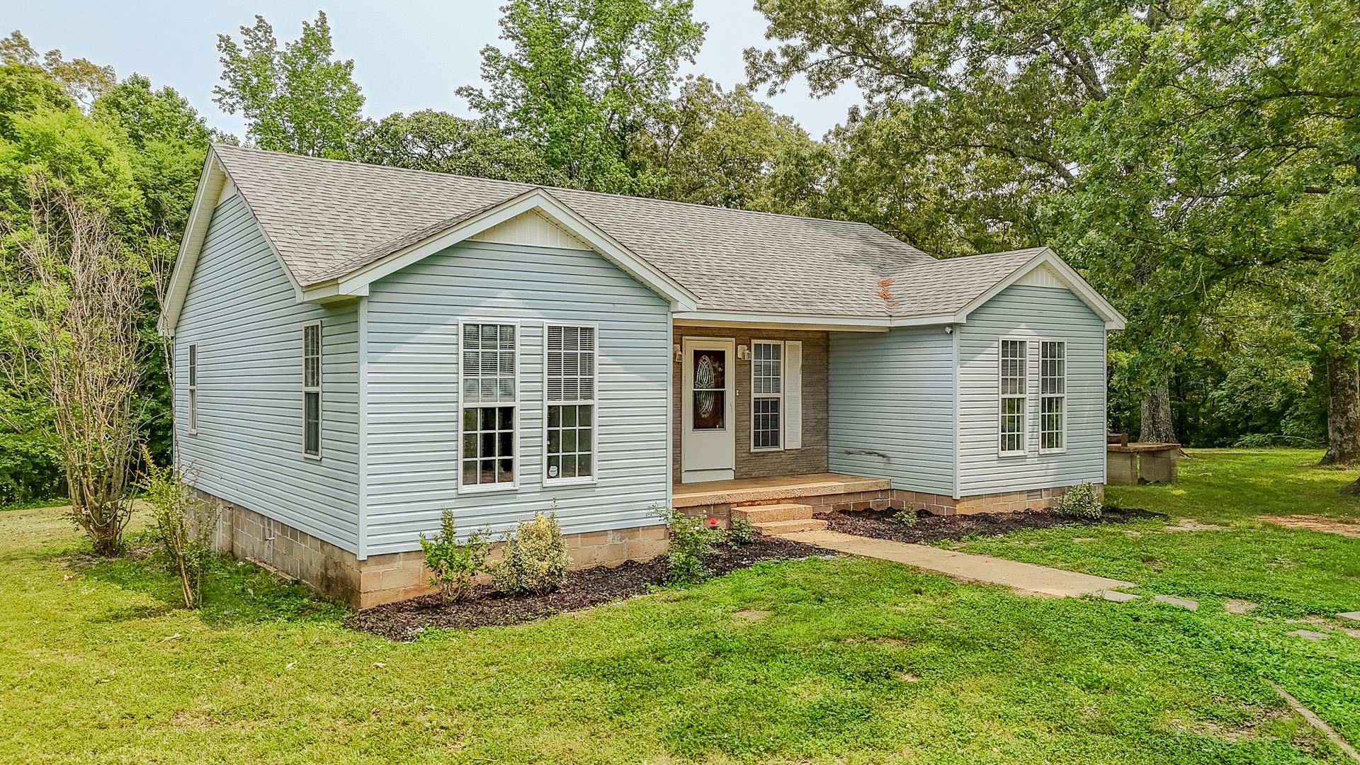 1633 Hardin Graveyard Road Adamsville, TN 38310 - Photo 1 of 33 a view of a house with a yard potted plants and large tree