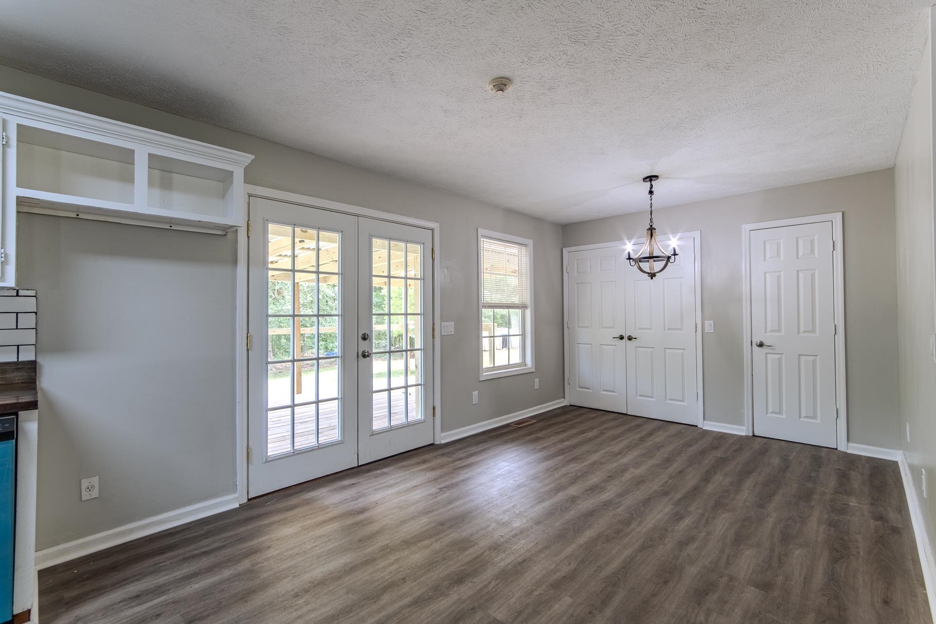 1633 Hardin Graveyard Road Adamsville, TN 38310 - Photo 12 of 33 a view of an empty room with wooden floor and a window