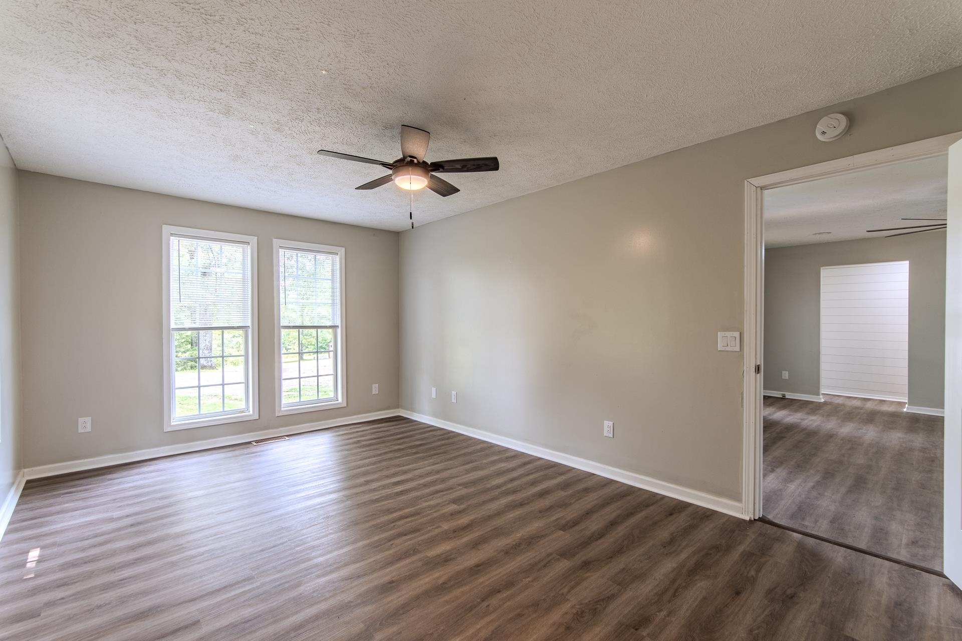 1633 Hardin Graveyard Road Adamsville, TN 38310 - Photo 16 of 33 a view of an empty room with a window and wooden floor