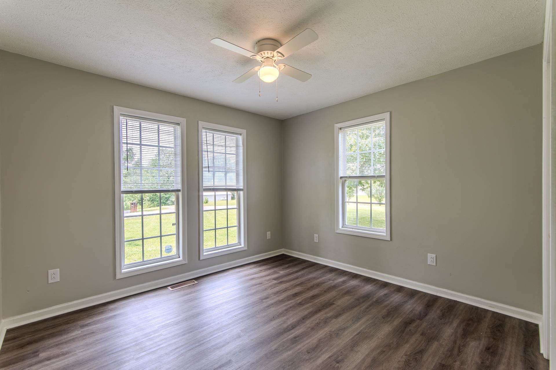 1633 Hardin Graveyard Road Adamsville, TN 38310 - Photo 20 of 33 an empty room with wooden floor and windows