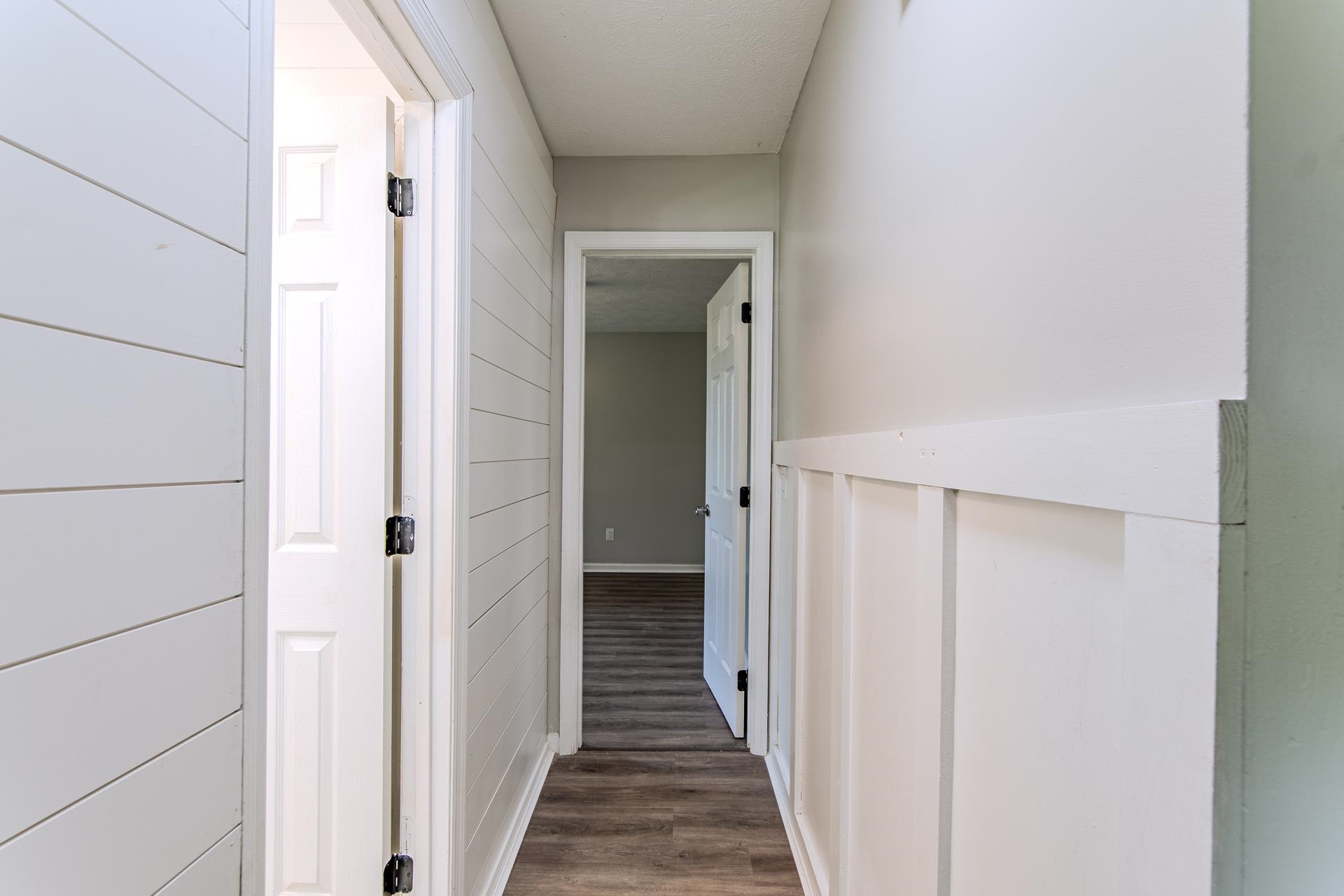 1633 Hardin Graveyard Road Adamsville, TN 38310 - Photo 23 of 33 a view of a hallway with wooden floor and a bathroom