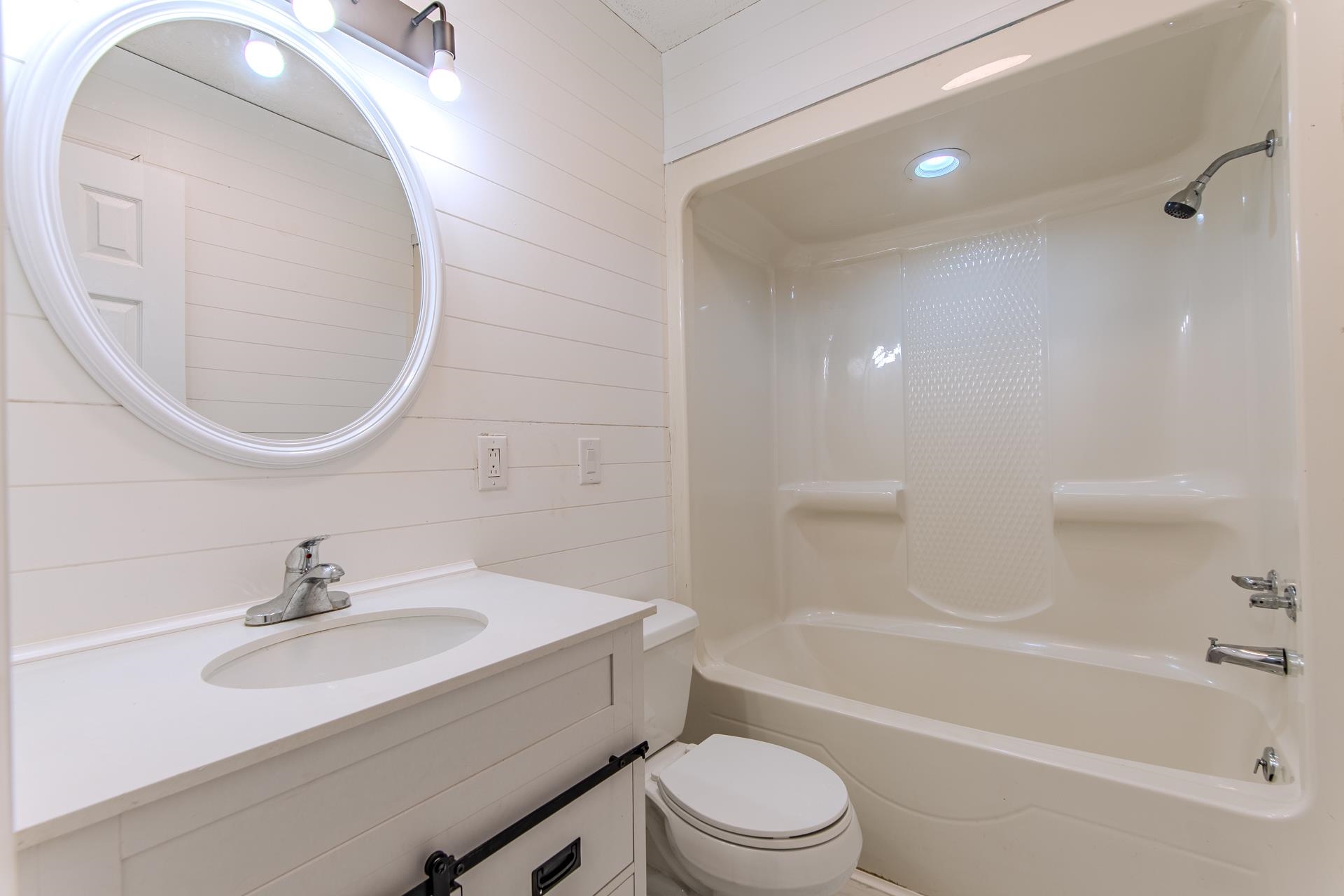 1633 Hardin Graveyard Road Adamsville, TN 38310 - Photo 24 of 33 a bathroom with a sink a toilet and a mirror