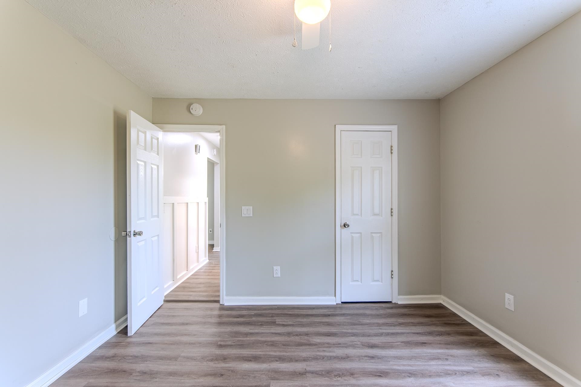 1633 Hardin Graveyard Road Adamsville, TN 38310 - Photo 26 of 33 a view of an empty room and wooden floor
