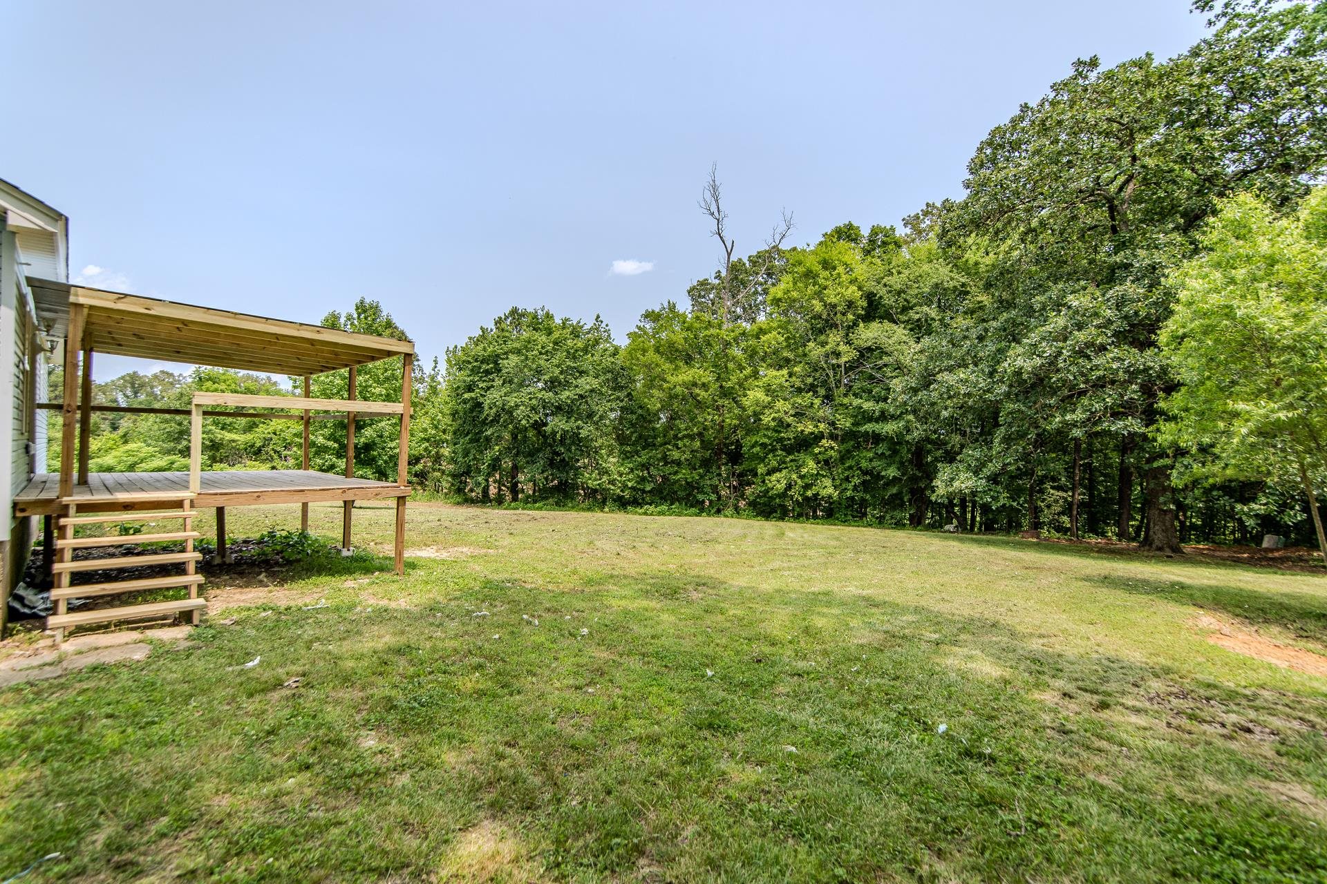 1633 Hardin Graveyard Road Adamsville, TN 38310 - Photo 32 of 33 a view of a big yard with potted plants and large tree