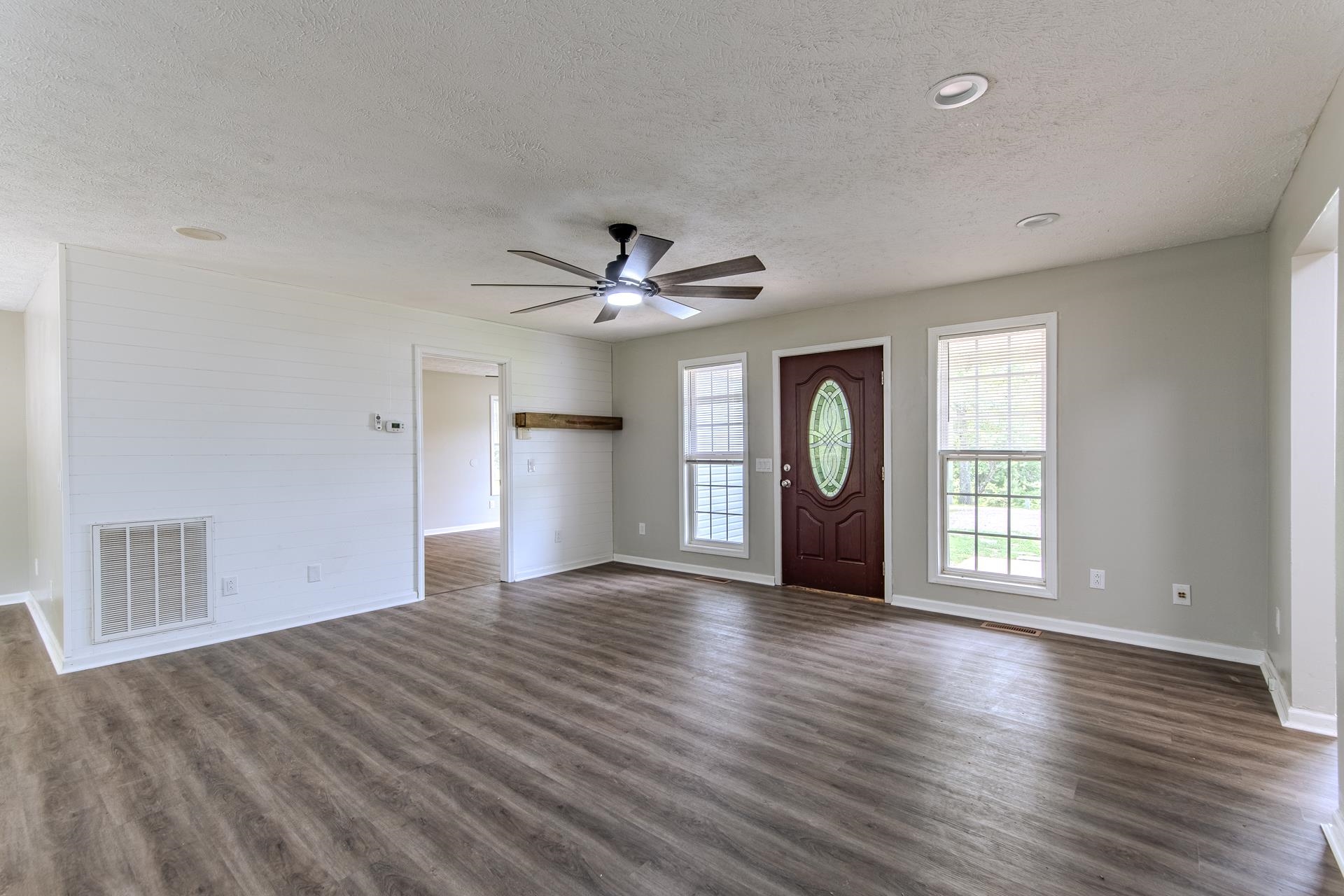 1633 Hardin Graveyard Road Adamsville, TN 38310 - Photo 8 of 33 a view of an empty room with window and wooden floor