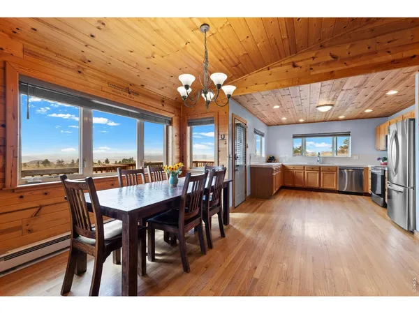 a dining room with furniture window and wooden floor