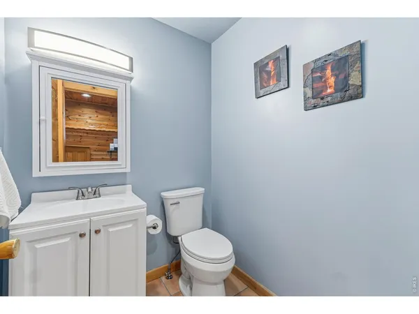 a bathroom with a toilet a sink and a mirror