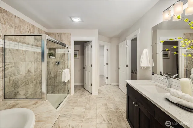 a spacious bathroom with a shower sink and mirror