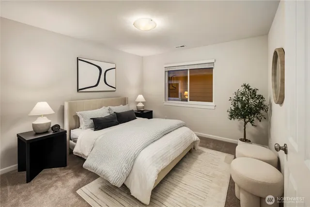 a bedroom with a bed and a potted plant