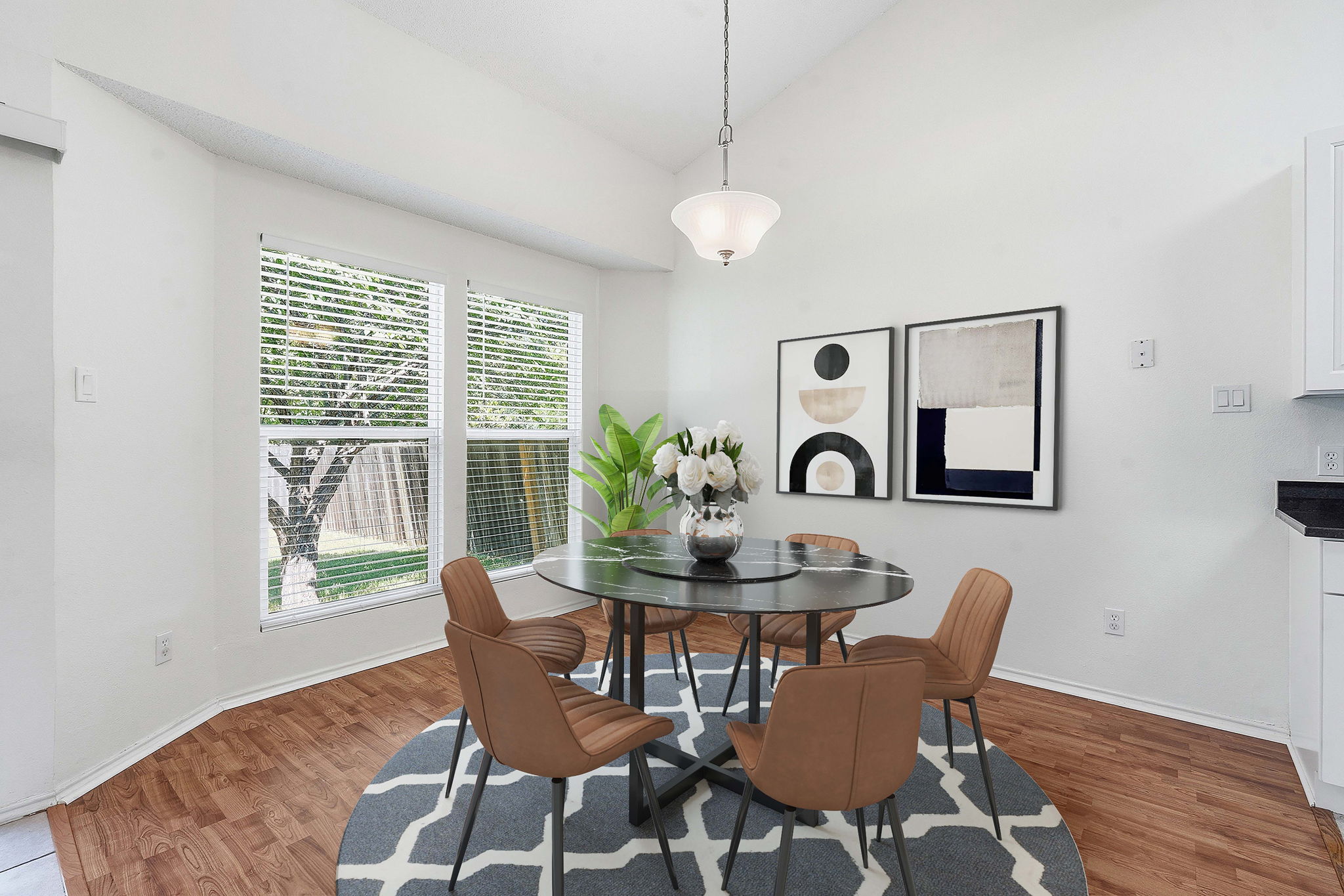 14818 Yellowleaf Trail Austin, TX 78728 - Photo 6 of 26 Dining area featuring abundant natural light from multiple windows, wood-finish flooring, a vaulted ceiling, and a hanging pendant light fixture