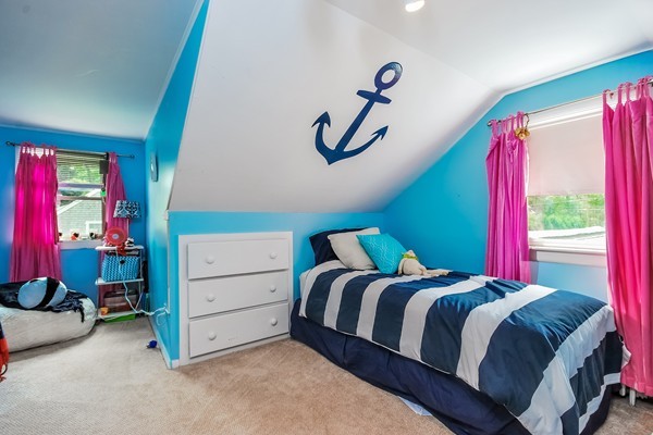 201 Converse Road Marion, MA 02738 - Photo 11 of 17 a bedroom with a bed and a chandelier