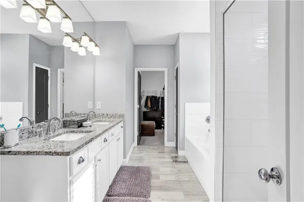 a bathroom with a bathtub and a shower