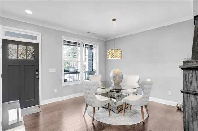 a dining room with furniture a chandelier and wooden floor