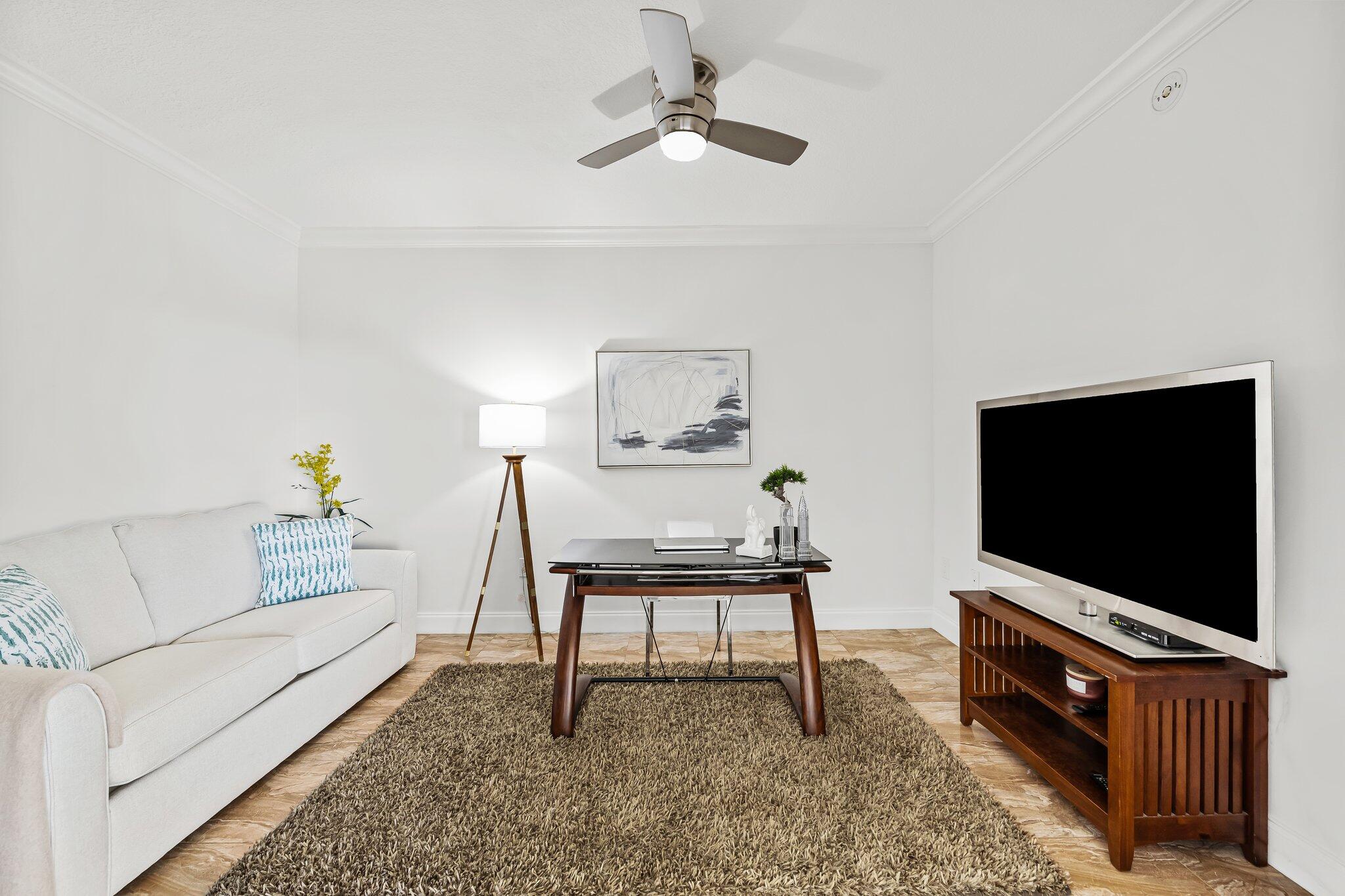 100 South Birch Road, Unit 1004 Fort Lauderdale, FL 33316 - Photo 17 of 39 a living room with furniture and a flat screen tv