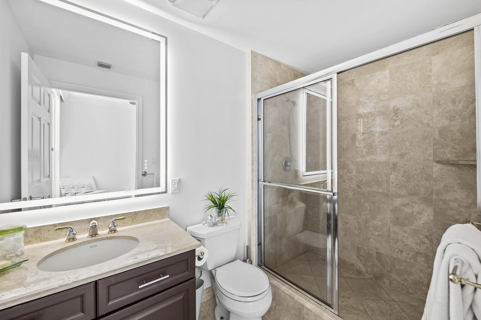 100 South Birch Road, Unit 1004 Fort Lauderdale, FL 33316 - Photo 18 of 39 a bathroom with a granite countertop sink toilet and shower