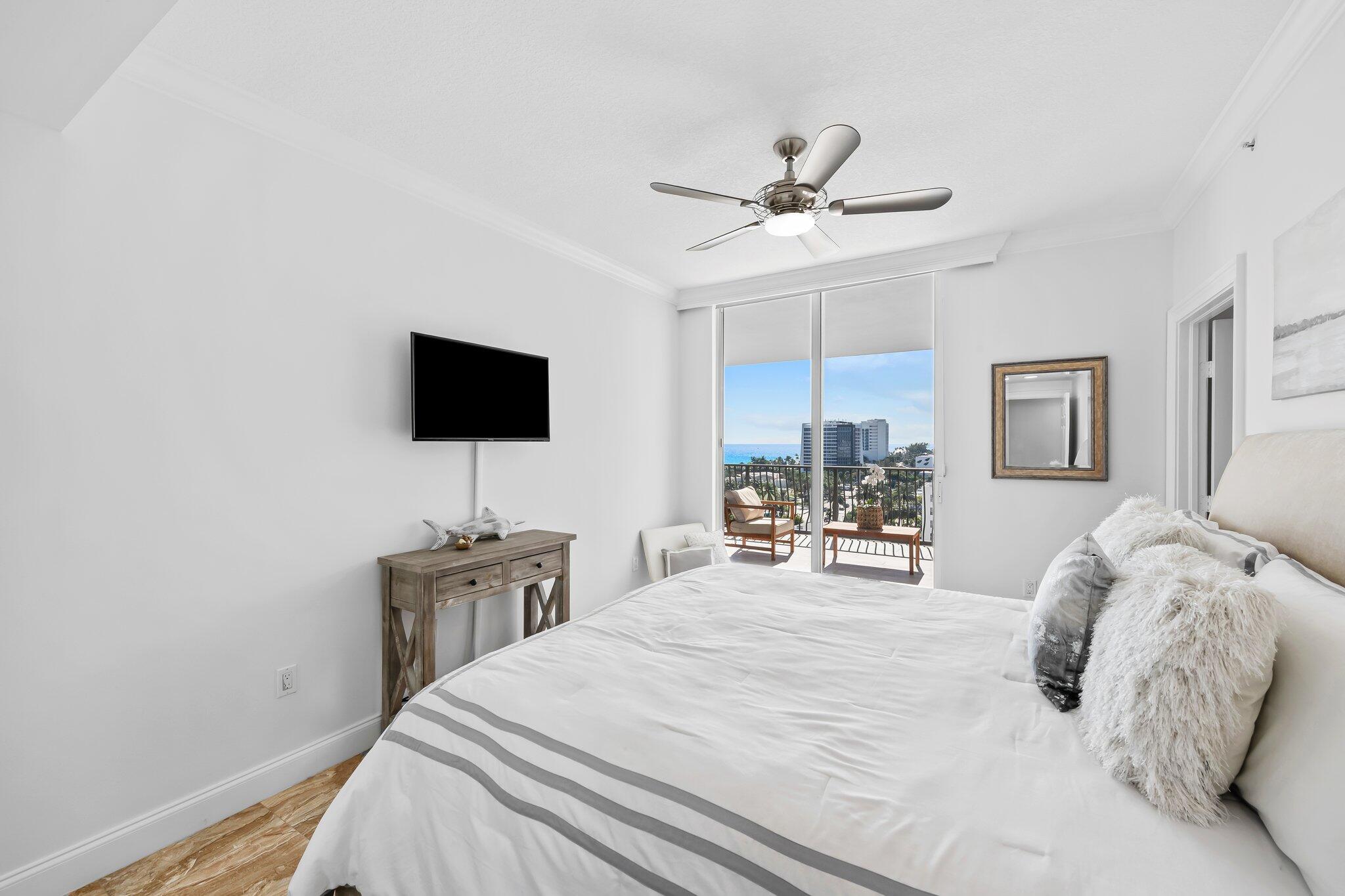 100 South Birch Road, Unit 1004 Fort Lauderdale, FL 33316 - Photo 19 of 39 a bedroom with a bed window and a flat screen tv