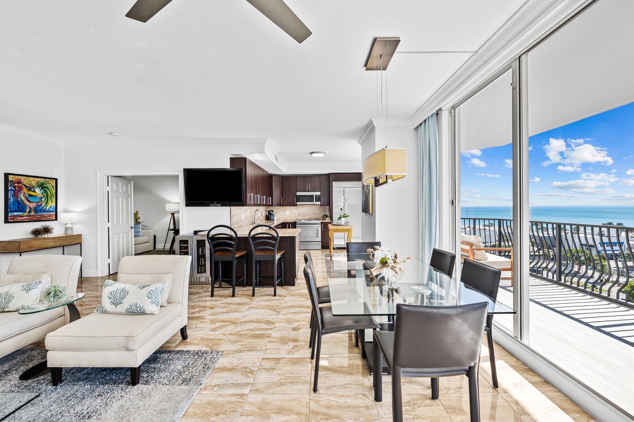 100 South Birch Road, Unit 1004 Fort Lauderdale, FL 33316 - Photo 2 of 39 a living room with furniture a flat screen tv and a large window