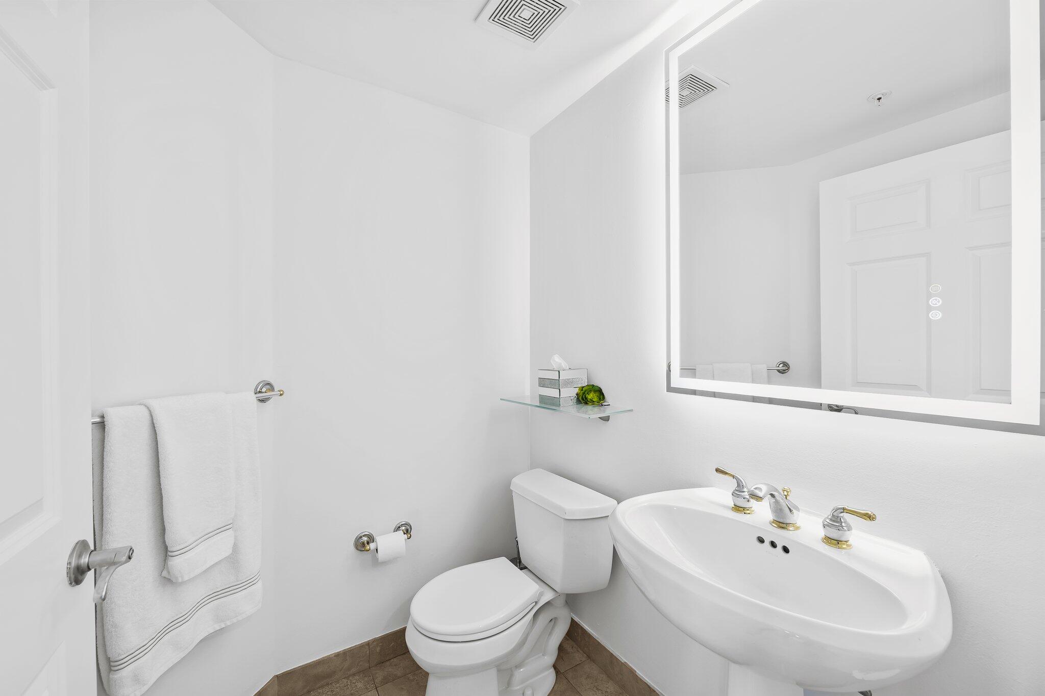 100 South Birch Road, Unit 1004 Fort Lauderdale, FL 33316 - Photo 23 of 39 a white toilet sitting next to a bathroom sink