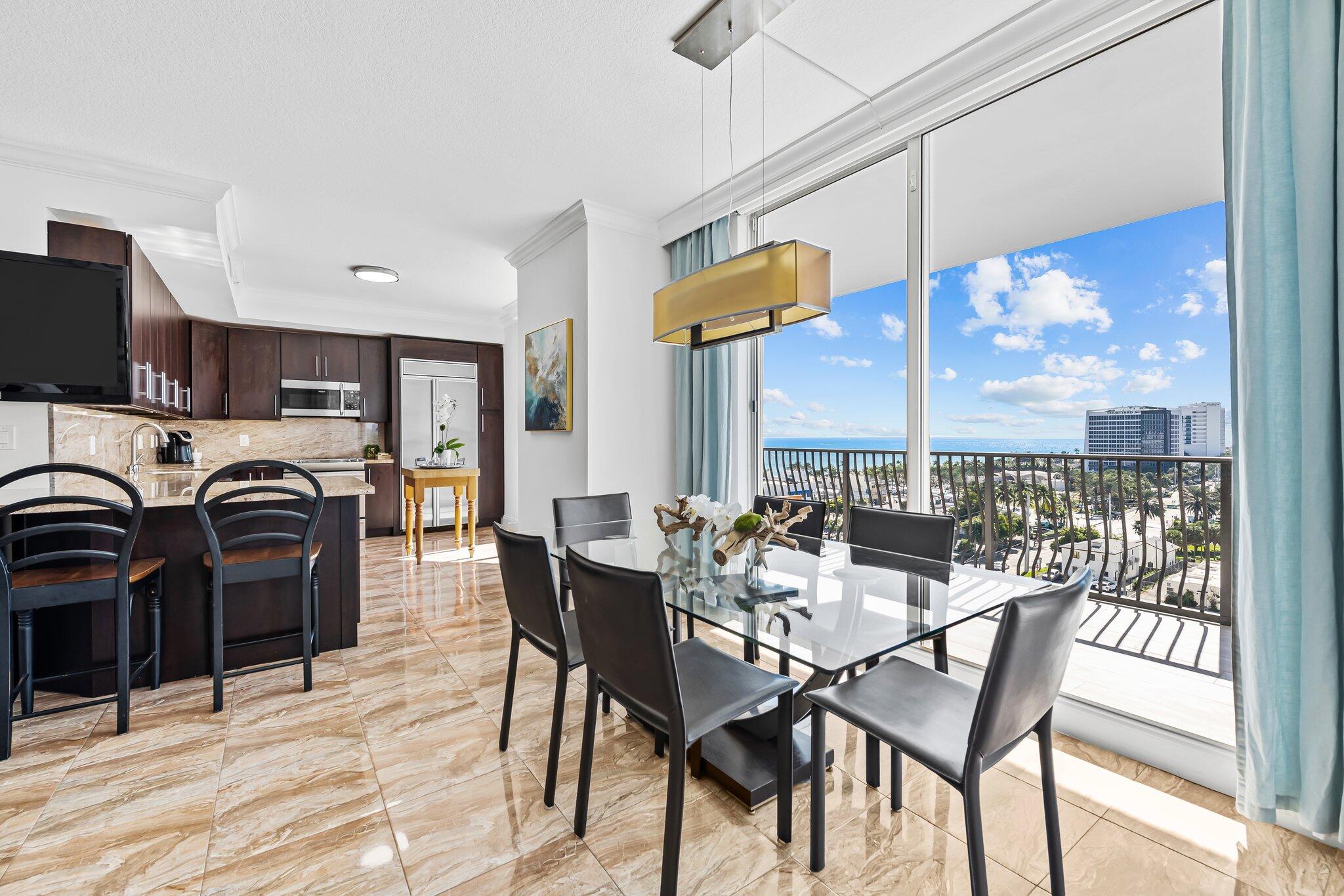 100 South Birch Road, Unit 1004 Fort Lauderdale, FL 33316 - Photo 3 of 39 a view of a dining area with furniture window and outside view