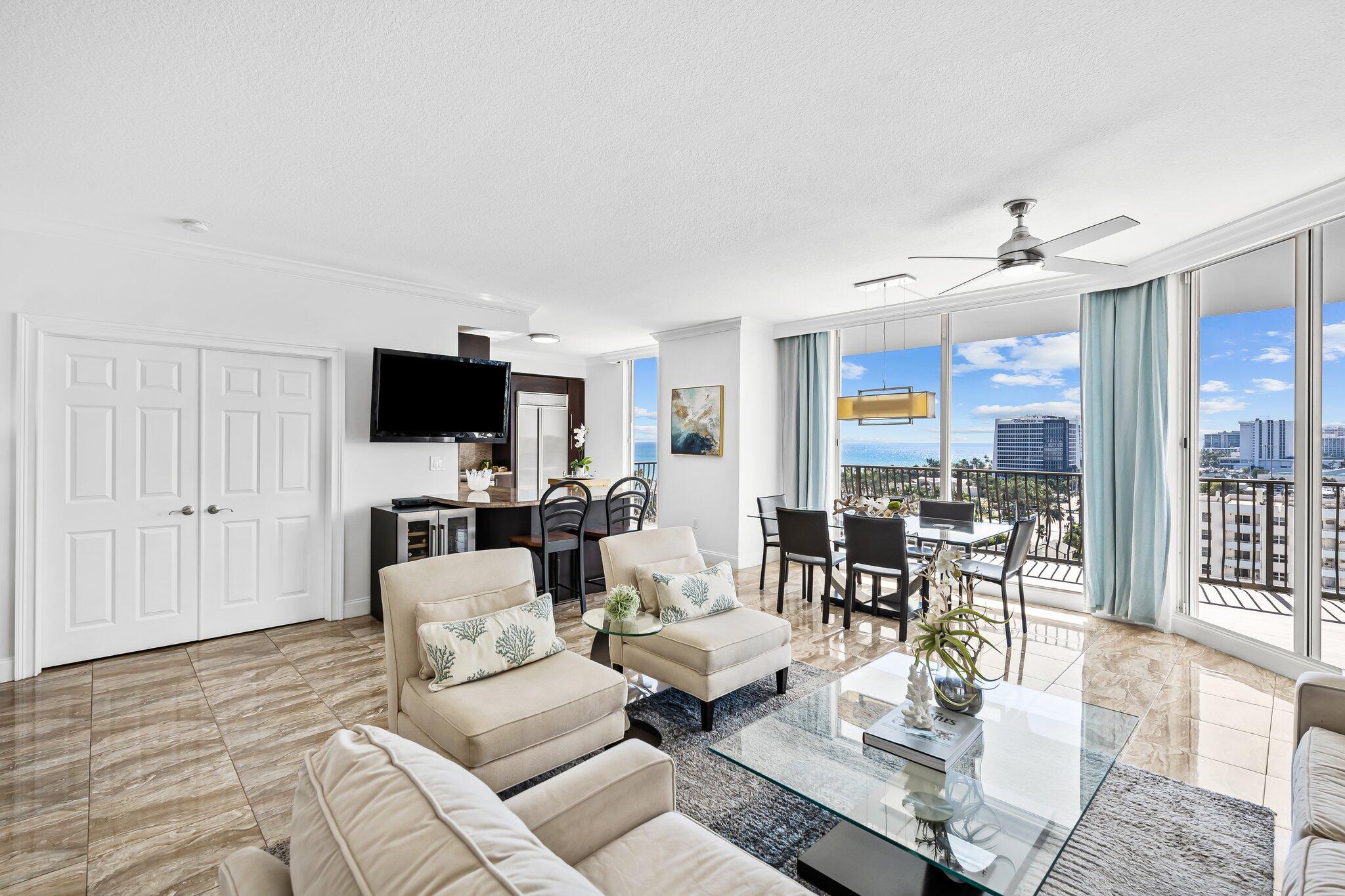 100 South Birch Road, Unit 1004 Fort Lauderdale, FL 33316 - Photo 7 of 39 a living room with furniture and a flat screen tv