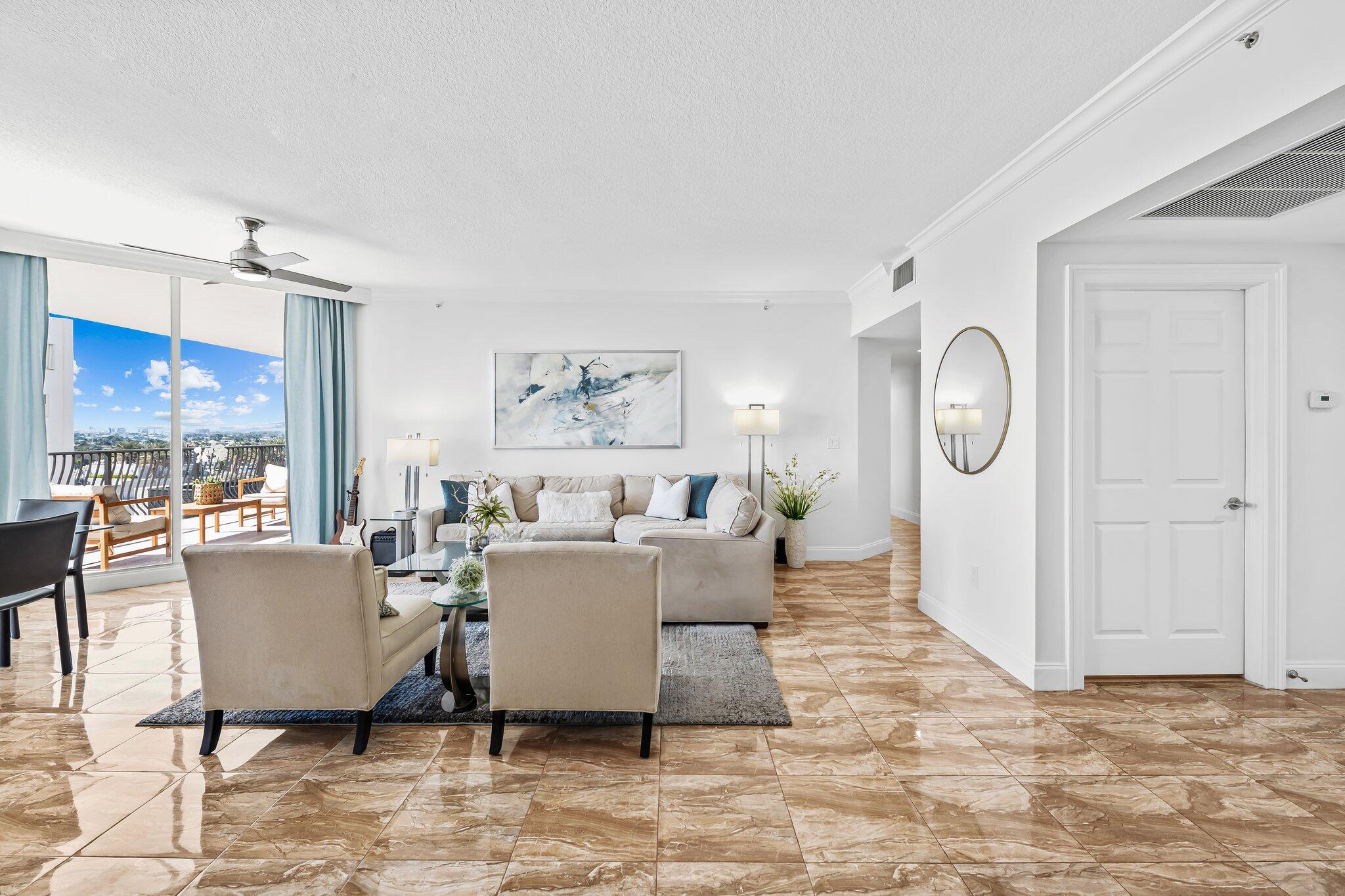 100 South Birch Road, Unit 1004 Fort Lauderdale, FL 33316 - Photo 8 of 39 a living room with furniture a window and a table