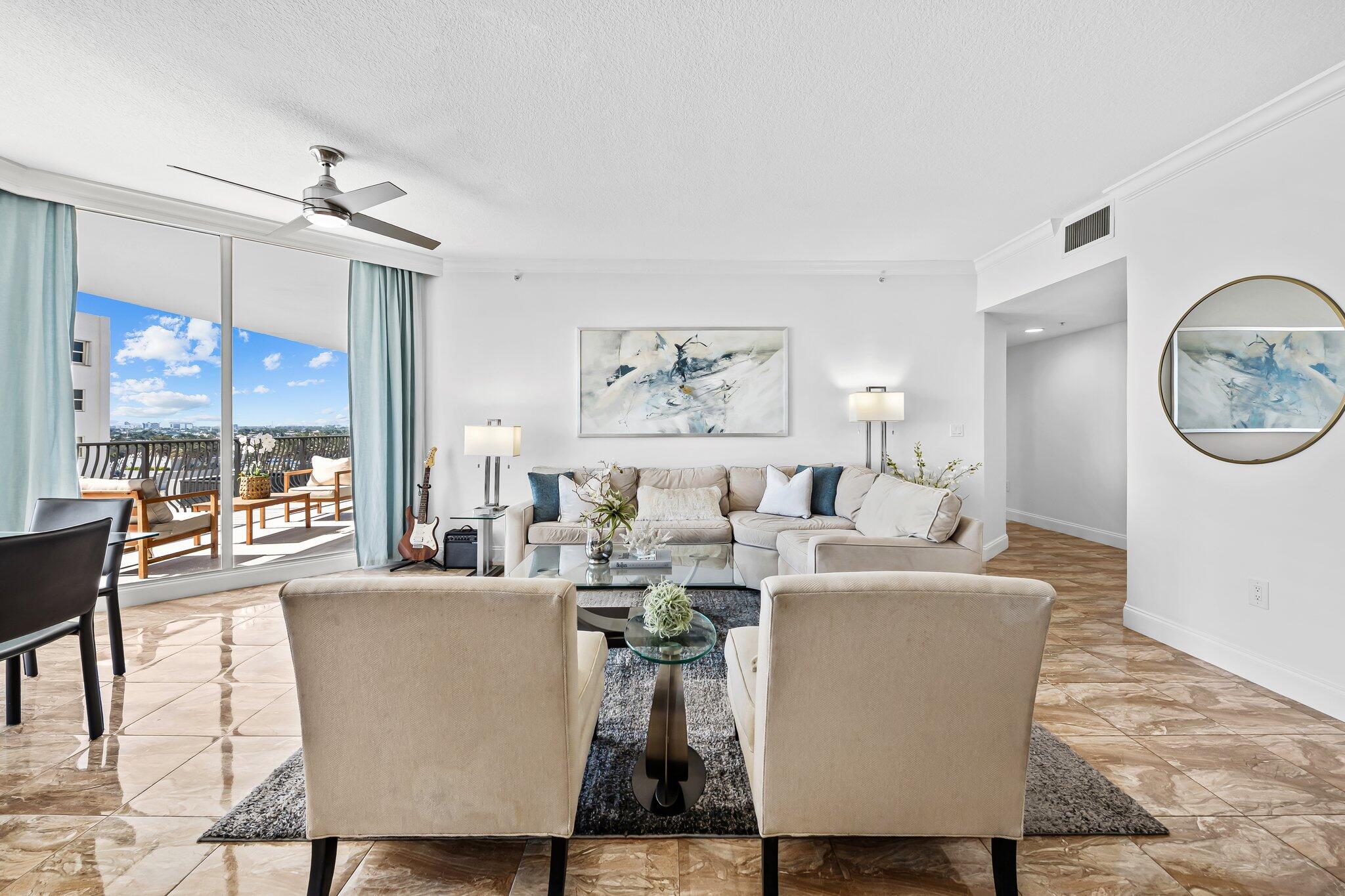 100 South Birch Road, Unit 1004 Fort Lauderdale, FL 33316 - Photo 9 of 39 a living room with fireplace furniture and a large window