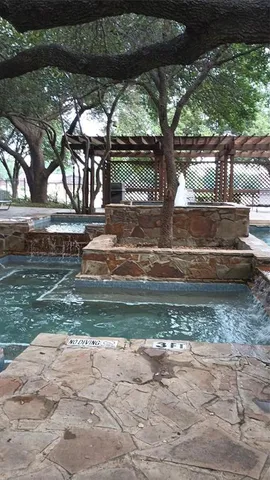 a backyard of a house with a yard and outdoor seating