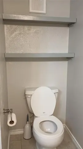 a white toilet sitting next to a bathroom sink