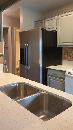 a view kitchen with a refrigerator sink and stove