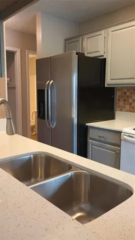 a view kitchen with a refrigerator sink and stove