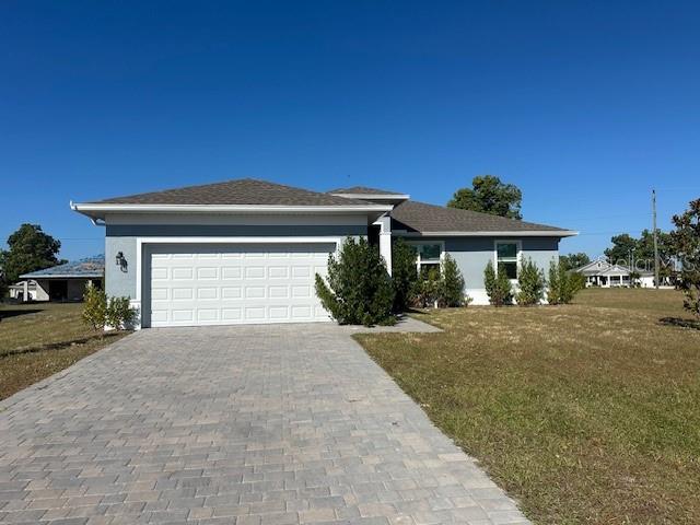16234 Maya Circle Punta Gorda, FL 33955 - Photo 2 of 19 a front view of a house with a yard and garage