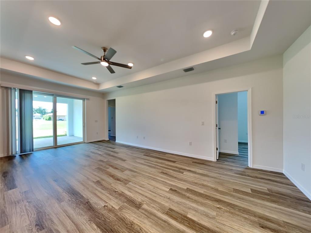 16234 Maya Circle Punta Gorda, FL 33955 - Photo 4 of 19 a view of an empty room with wooden floor and a ceiling fan
