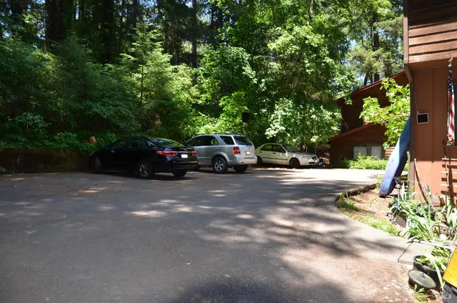 a view of street along with house and trees