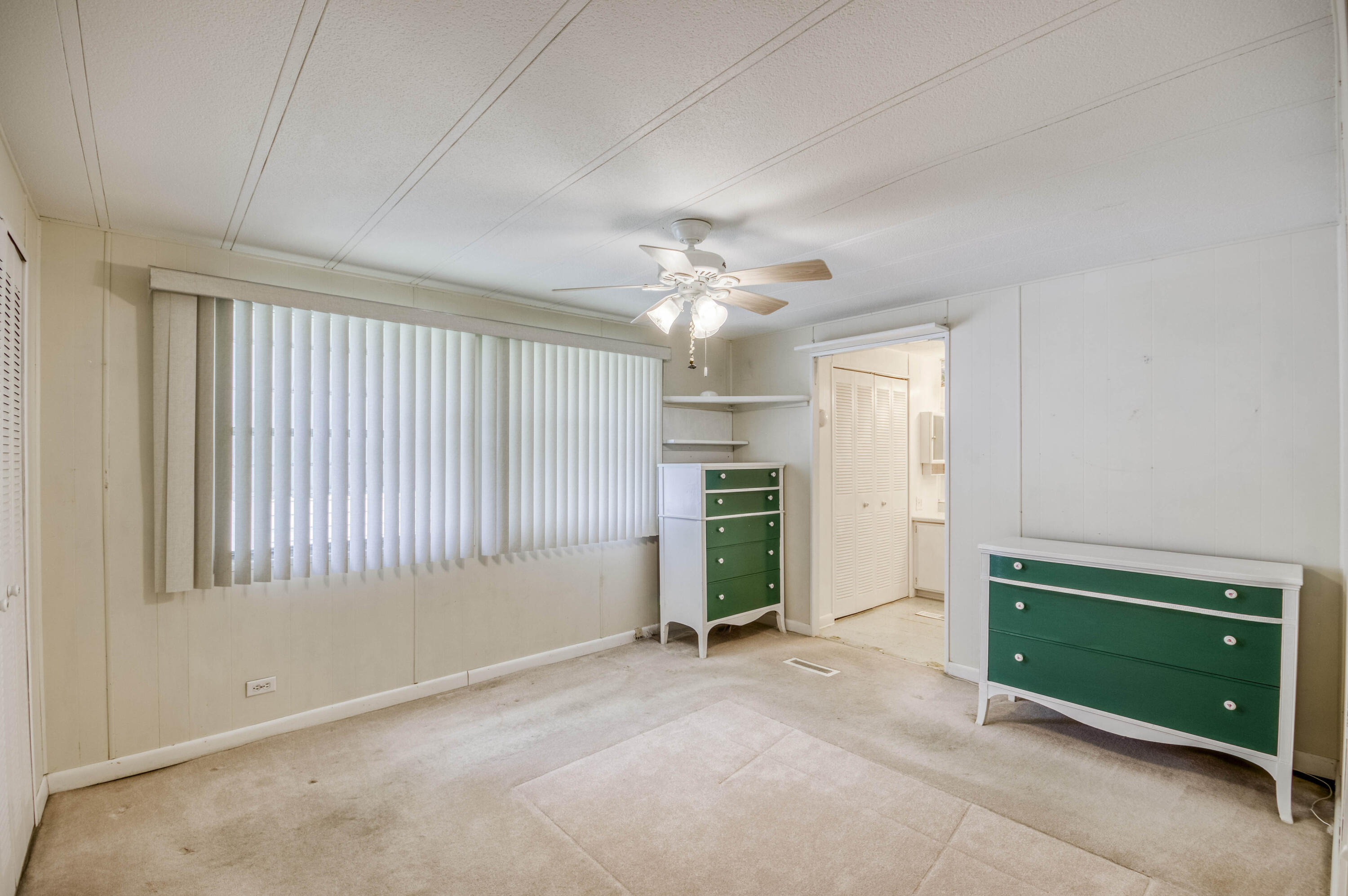 4800 Southeast Federal Highway, Unit 17 Stuart, FL 34997 - Photo 11 of 29 an empty room with windows and cabinet
