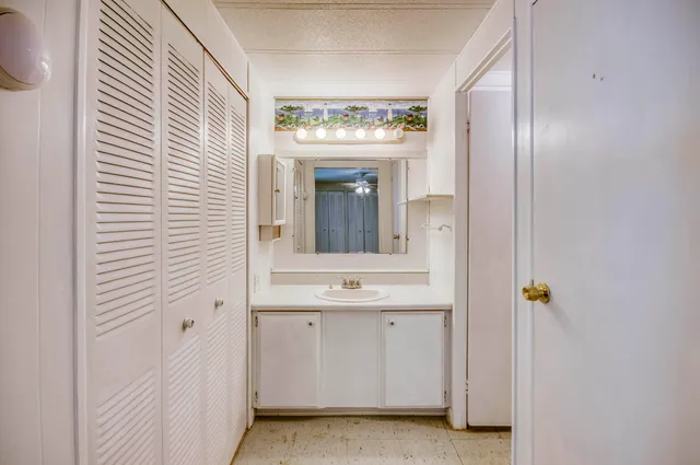 a bathroom with a sink a mirror and a window