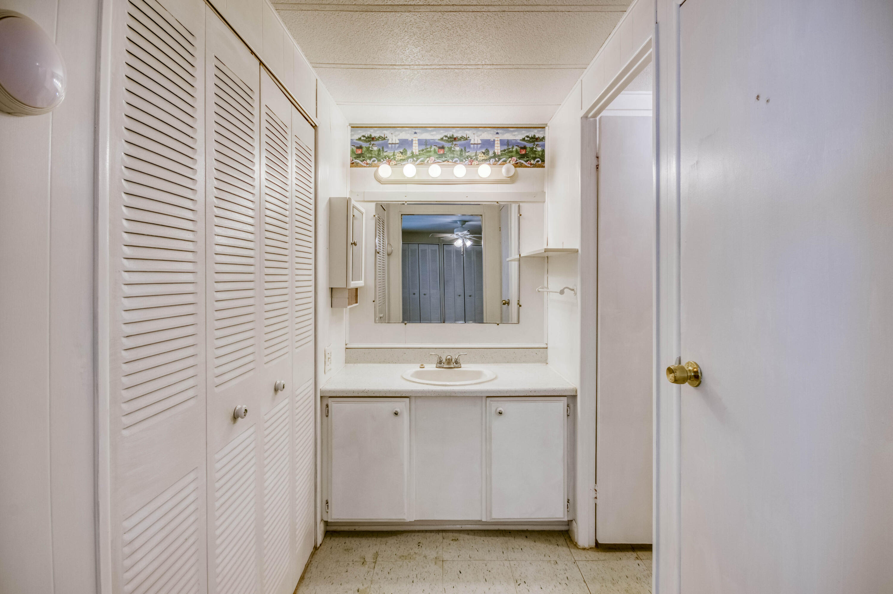 4800 Southeast Federal Highway, Unit 17 Stuart, FL 34997 - Photo 13 of 29 a bathroom with a sink a mirror and a window