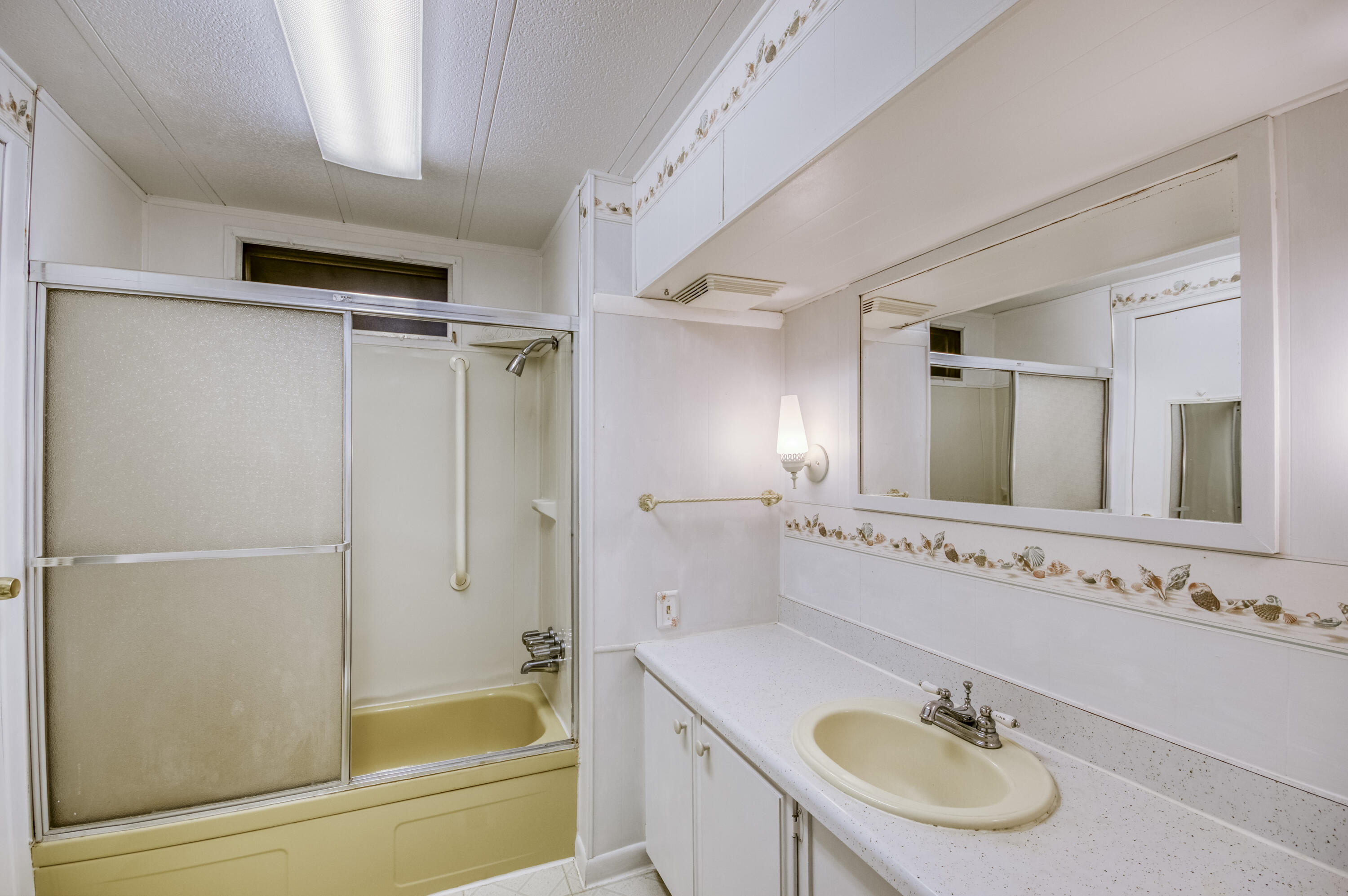 4800 Southeast Federal Highway, Unit 17 Stuart, FL 34997 - Photo 15 of 29 a bathroom with a sink and a mirror