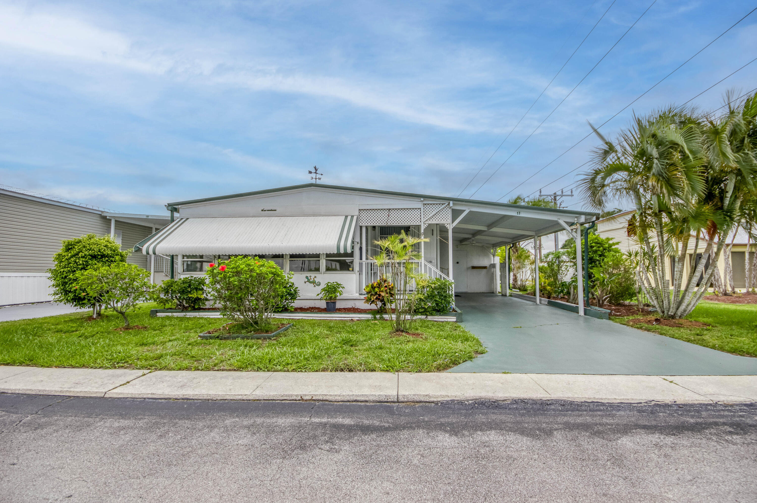 4800 Southeast Federal Highway, Unit 17 Stuart, FL 34997 - Photo 20 of 29 a view of a house with a yard and potted plants