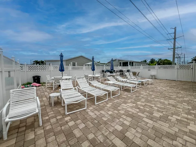 a view of a patio with a table and chairs