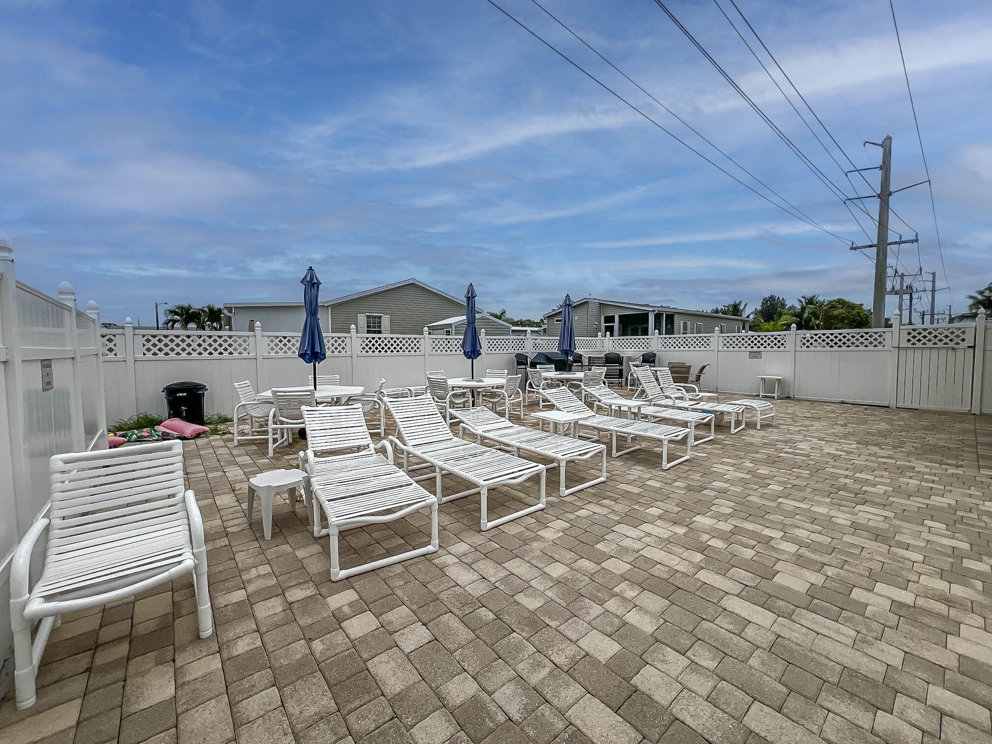 4800 Southeast Federal Highway, Unit 17 Stuart, FL 34997 - Photo 25 of 29 a view of a patio with a table and chairs