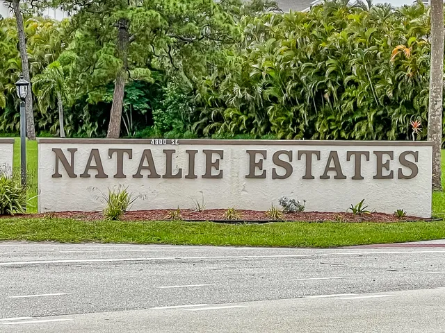 a view of sign board with a yard