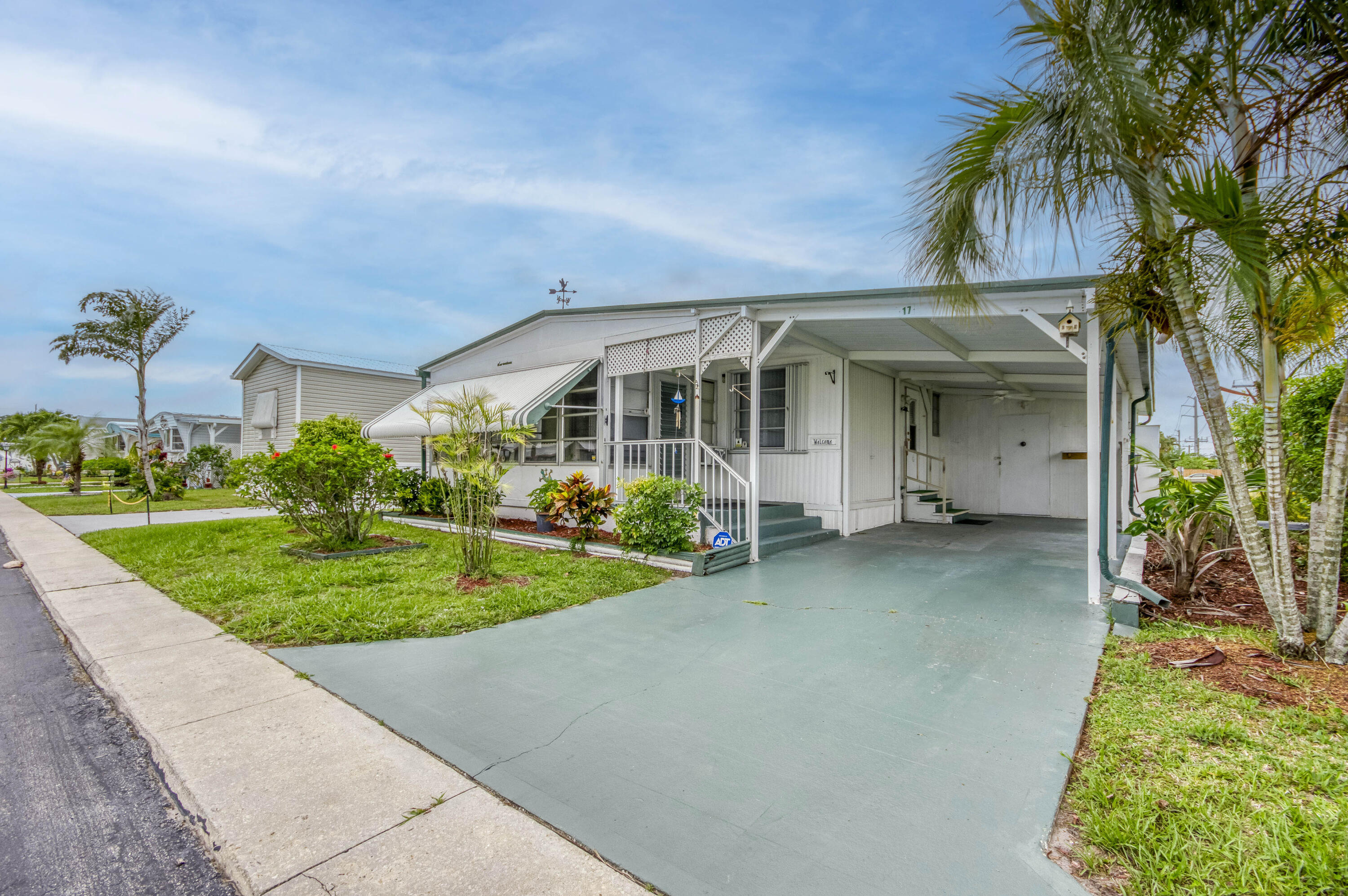 4800 Southeast Federal Highway, Unit 17 Stuart, FL 34997 - Photo 3 of 29 front view of a house with a garden