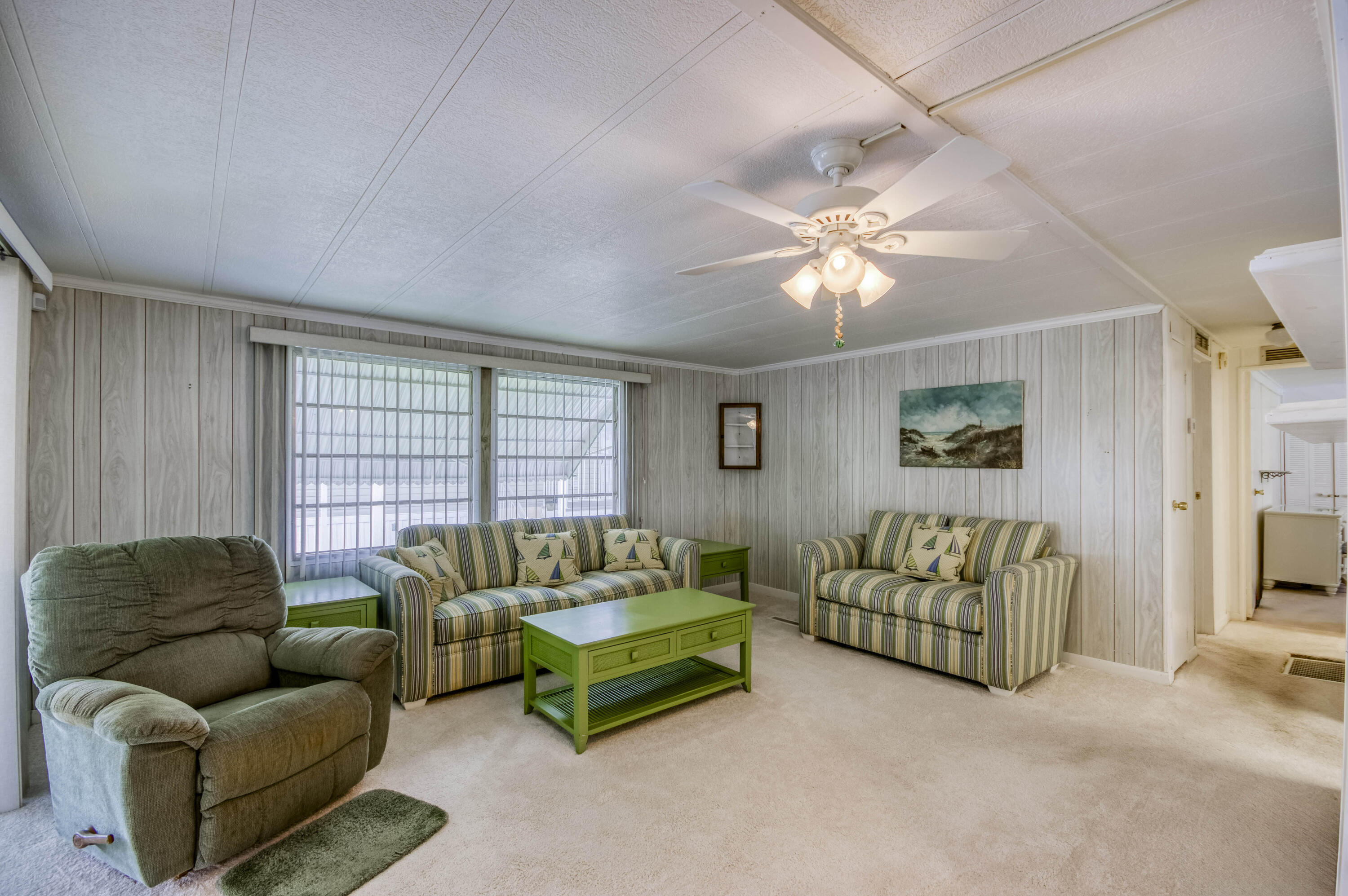 4800 Southeast Federal Highway, Unit 17 Stuart, FL 34997 - Photo 4 of 29 a living room with furniture and a large window
