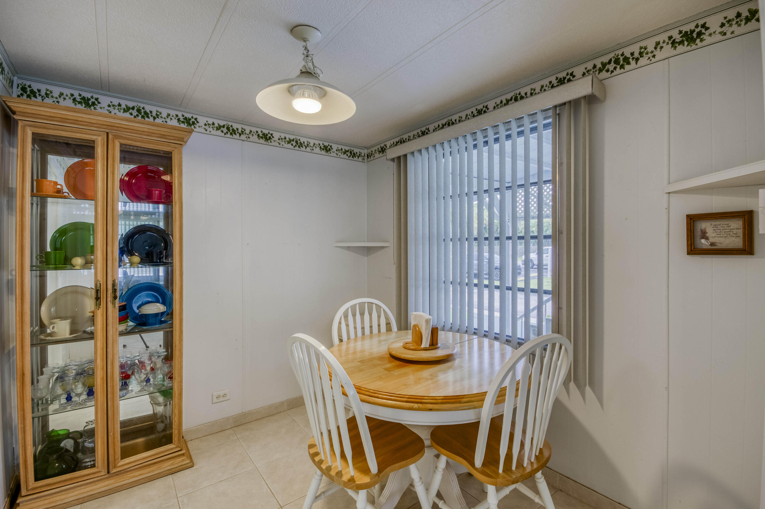 4800 Southeast Federal Highway, Unit 17 Stuart, FL 34997 - Photo 7 of 29 a view of a dining room with furniture and chandelier