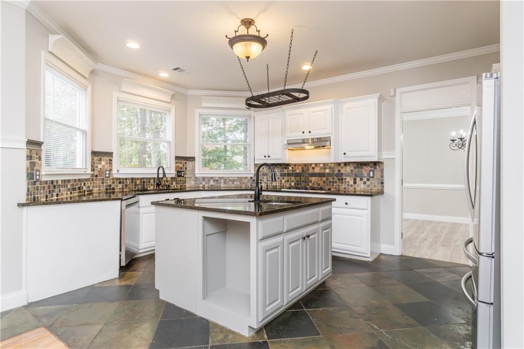 6710 Timber Cove Cumming, GA 30041 - Photo 6 of 51 a kitchen with stainless steel appliances granite countertop a stove a sink dishwasher and a refrigerator